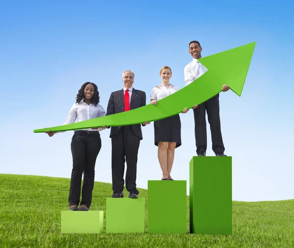 Business people holding growth graph — Stock Photo, Image