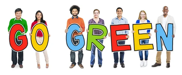 Pessoas segurando ir texto verde — Fotografia de Stock
