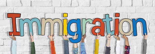 Manos sosteniendo la palabra Inmigración — Foto de Stock