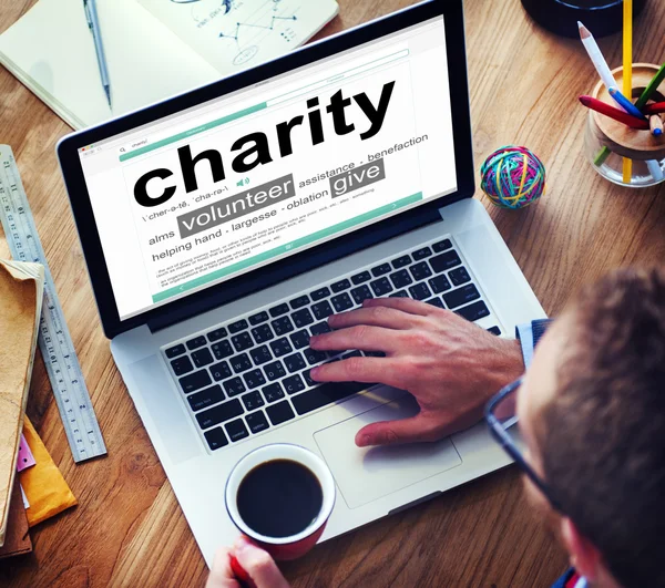 Man Reading the Definition of Charity — Stock Photo, Image