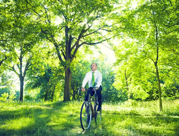 Businessman riding on bicycle — Stock Photo, Image