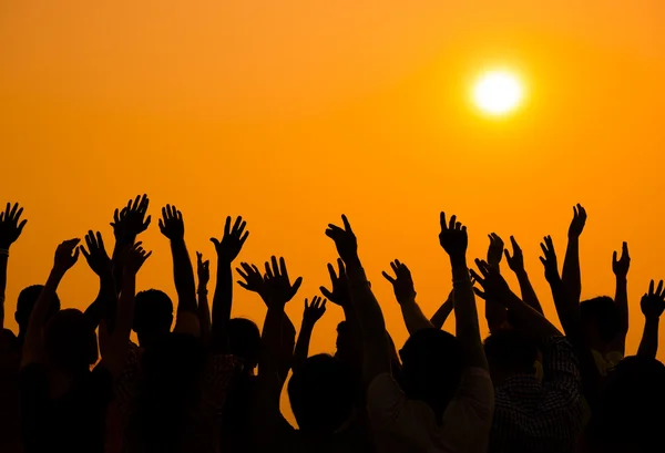 People raised hands up on sunset — Stock Photo, Image