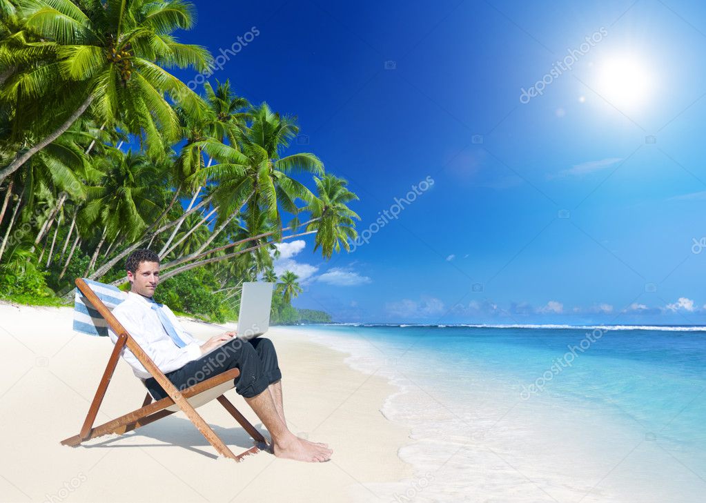 Businessman working on beach