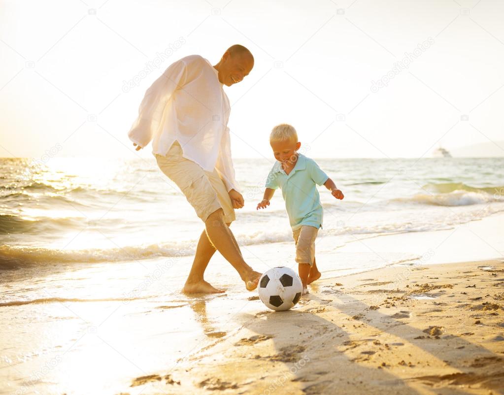 Father and son playing football