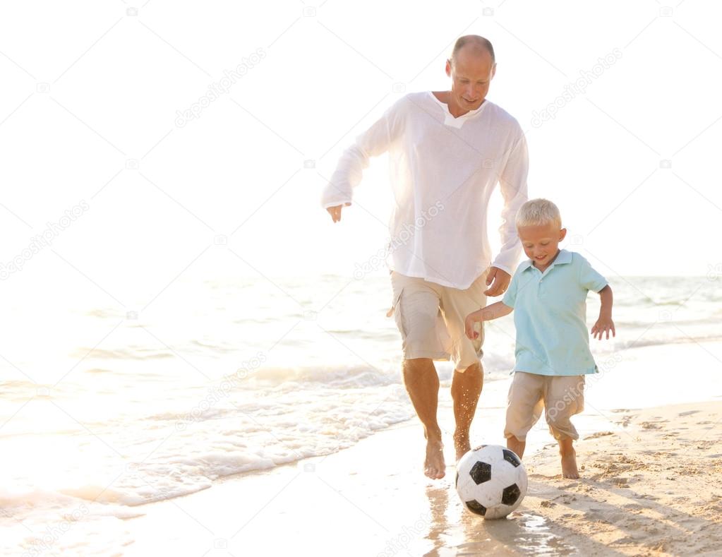 Father and son playing football together