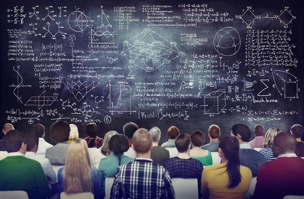 People with Formula on Chalkboard — Stock Photo, Image