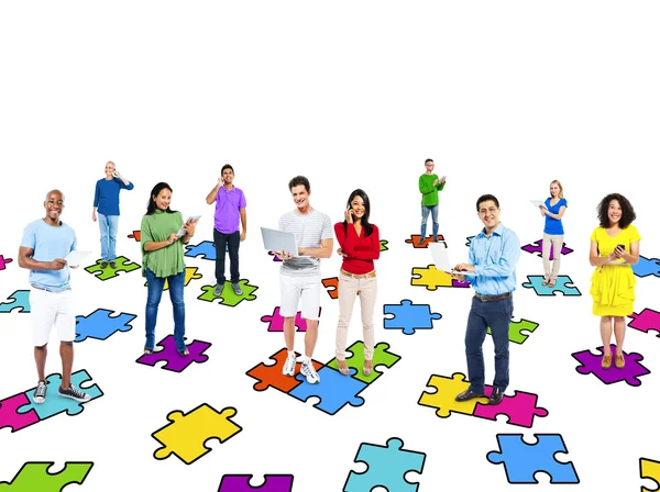 People standing on puzzle pieces — Stock Photo, Image