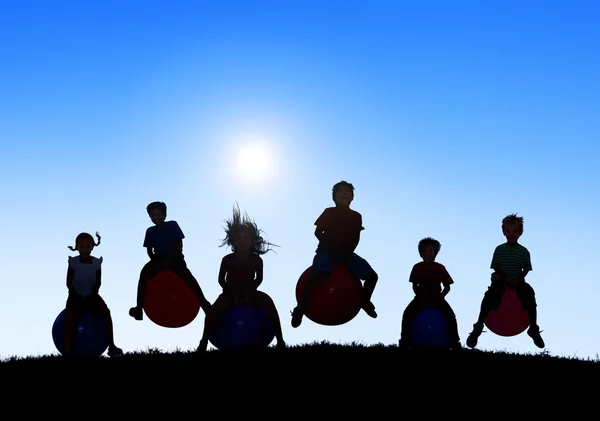 Silhouettes of Children Playing