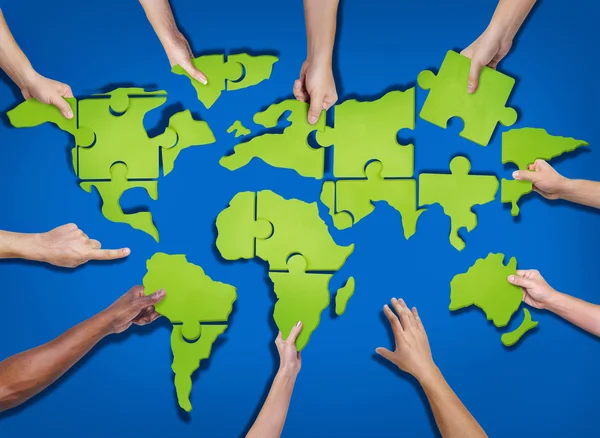 People Forming World Map with Puzzle — Stock Photo, Image