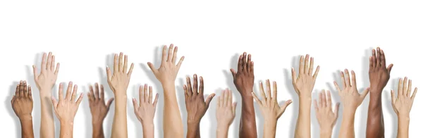 Manos multiétnicas diversas levantadas — Foto de Stock