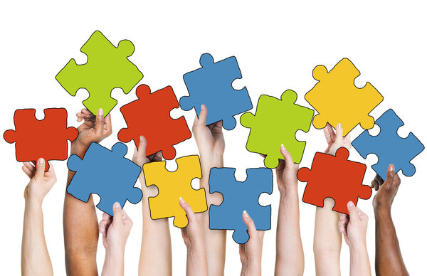 Hands Holding Jigsaw Puzzle Pieces