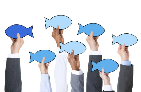 Business People Holding Fish Symbols — Stock Photo, Image