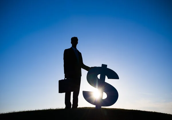 Businessman holding Dollar sign — Stock Photo, Image