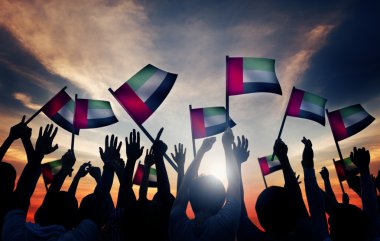 People Waving Flags of UAE clipart