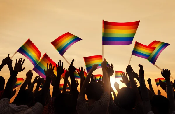 Pessoas segurando símbolos do orgulho gay — Fotografia de Stock