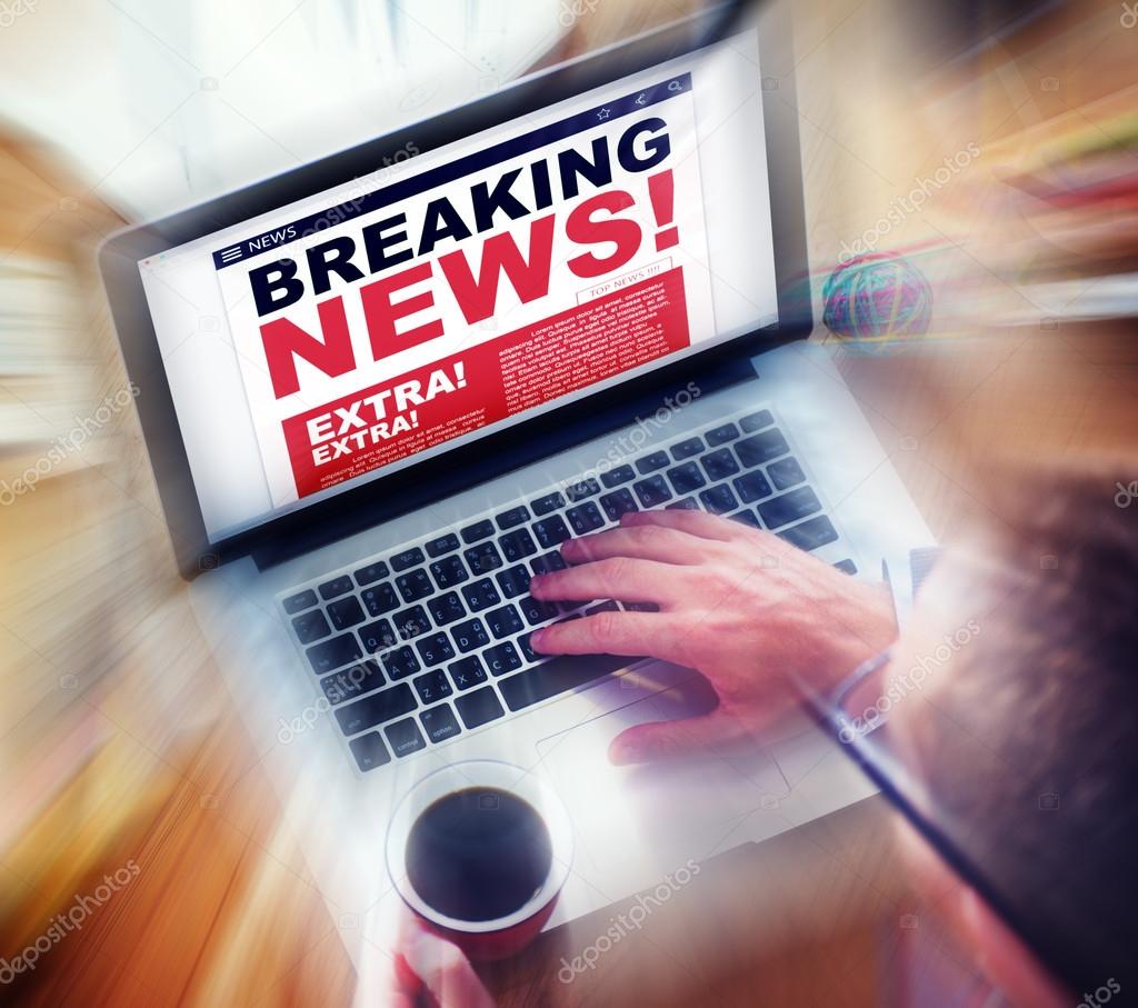 Man using laptop with Breaking News