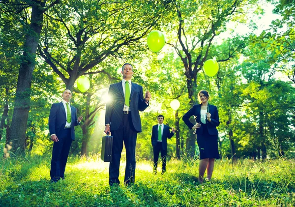 Business people holding balloon — Stock Photo, Image