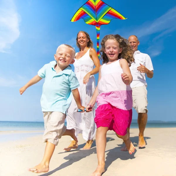 Family running with kite — Stock Photo, Image
