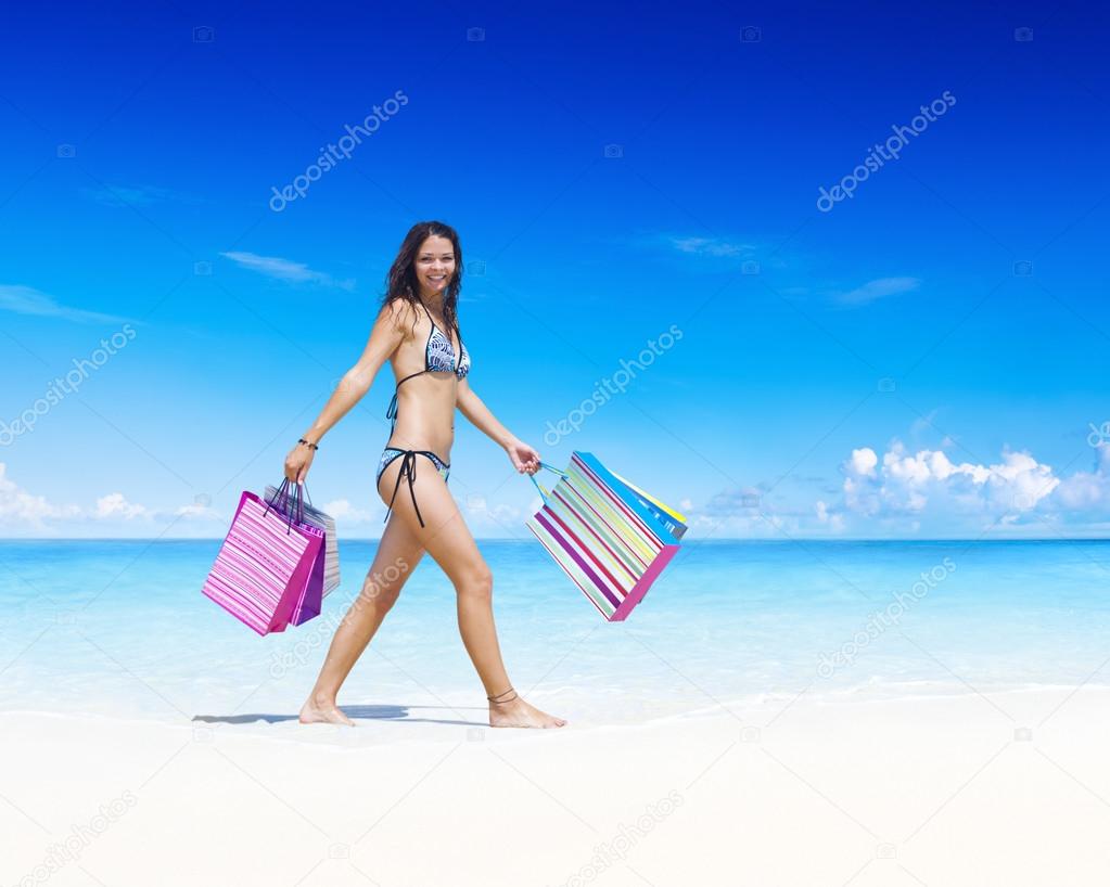 Woman with shopping bag on beach