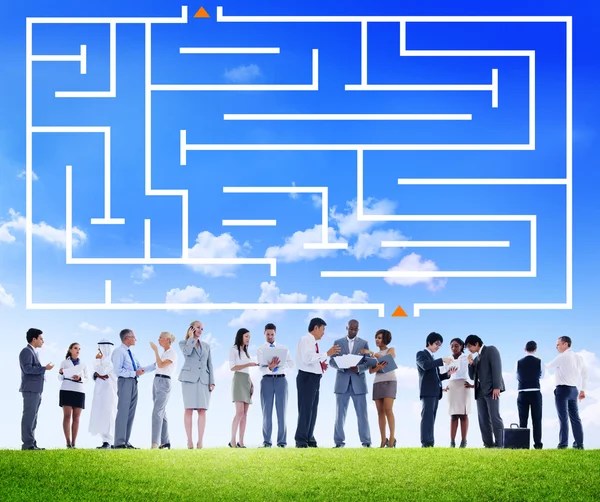 Business people under labyrinth — Stock Photo, Image