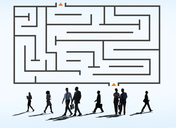 Business people under labyrinth — Stock Photo, Image
