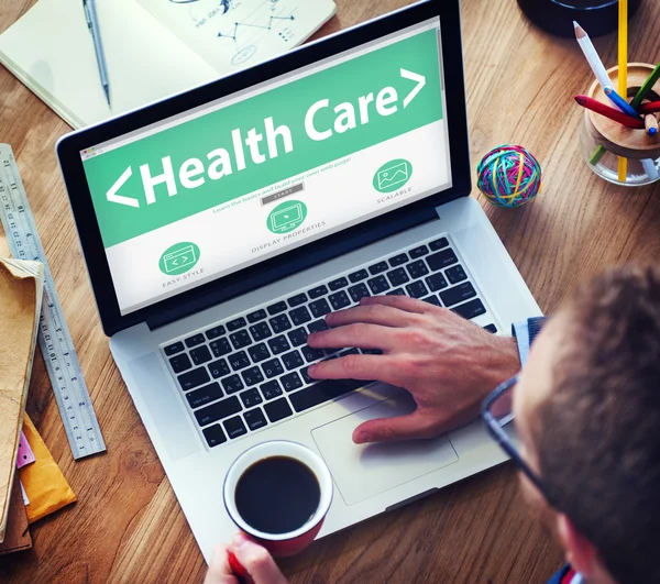 Man working on laptop with Health Care — Stock Photo, Image