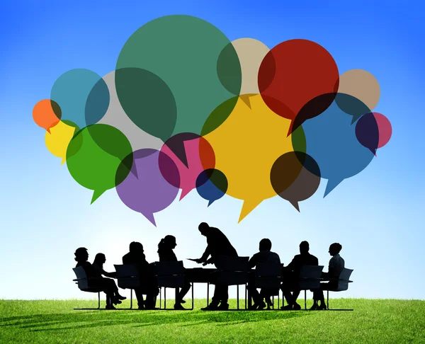 Business meeting with speech bubbles — Stock Photo, Image