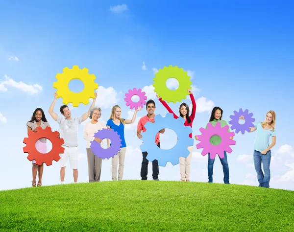 Diverse people with gears — Stock Photo, Image