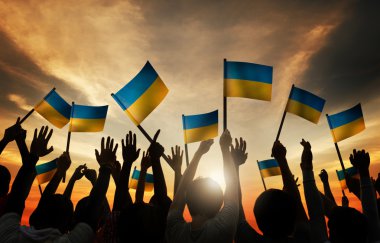 Group of People Waving Ukranian Flags clipart