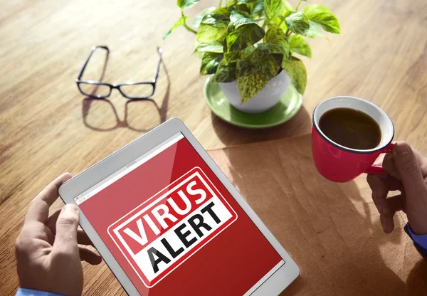 Hands holding tablet with Virus Alert — Stock Photo, Image