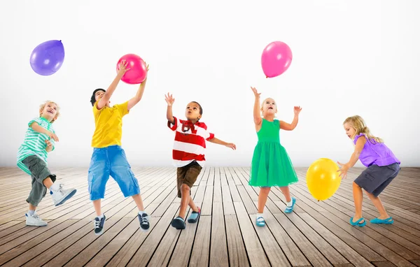 Children Playing with Balloons Royalty Free Stock Photos