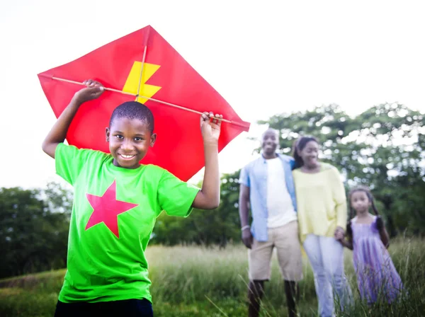 Happy African family playing with a kite — Zdjęcie stockowe