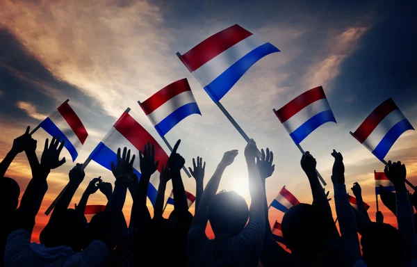 Groep mensen zwaaien vlag van Nederland — Stockfoto