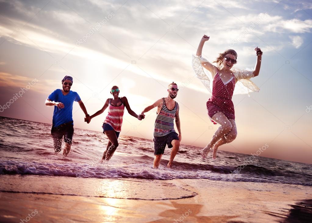 happy friends jumping on the beach