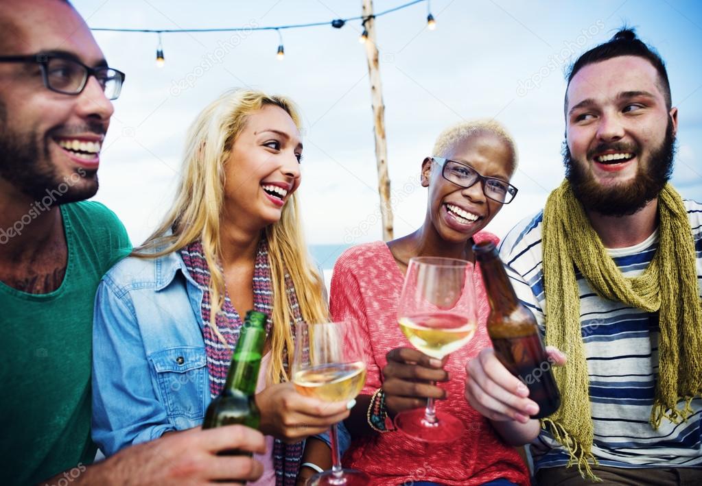 cheerful friends hanging out on the beach party