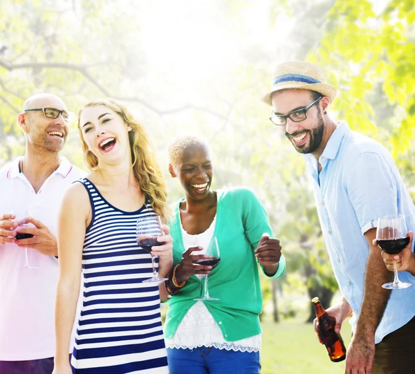 Diverse cheerful friends hanging out at outdoors party — Stock Photo, Image