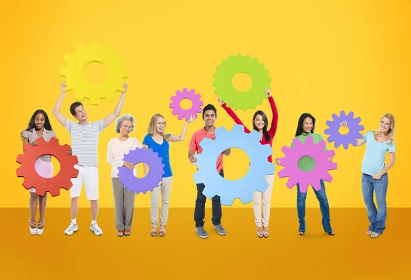 Diversity People holding Gears — Stock Photo, Image