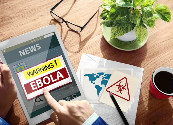 Man using tablet and Ebola Warning — Stock Photo, Image