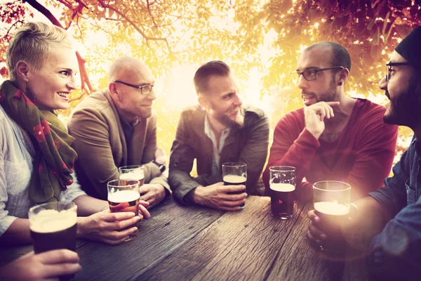 Diverse cheerful friends hanging out at outdoors party — Stock Photo, Image