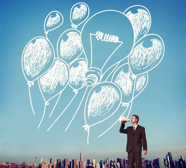 Businessman with megaphone against cityscape — Stock Photo, Image