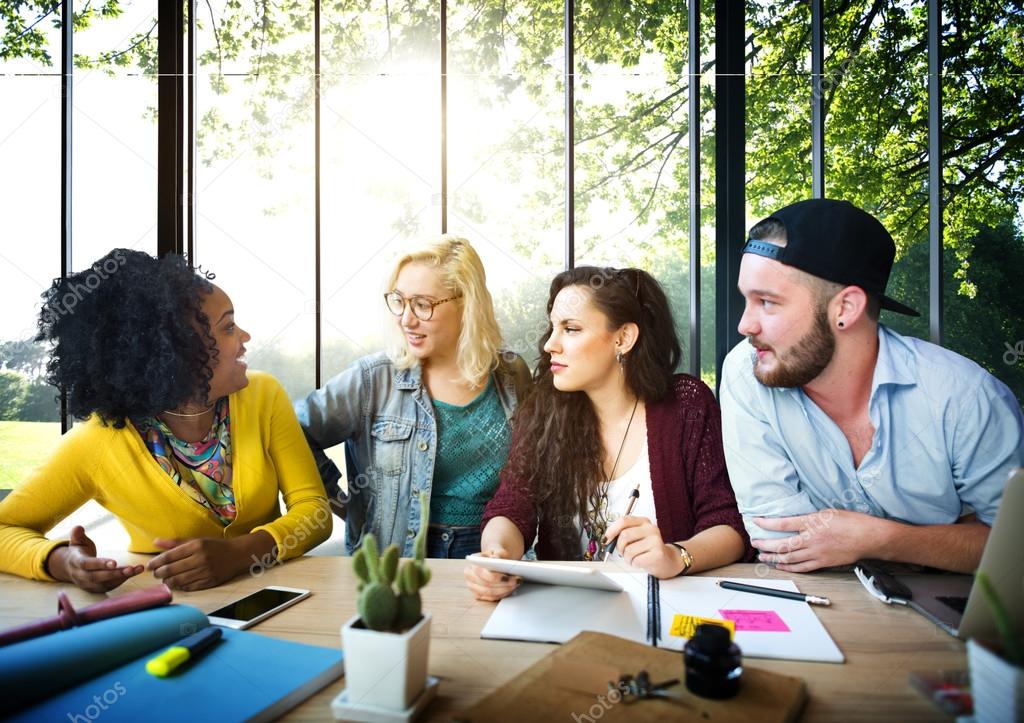 Diverse college students brainstorming in classroom