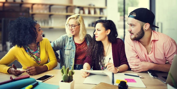 Diverse college students brainstorming in classroom