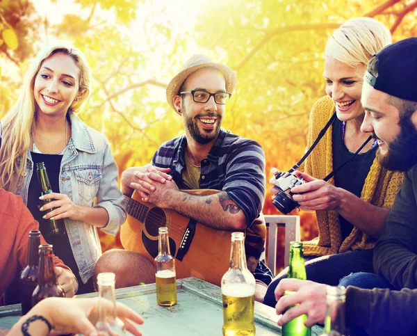 Diverse cheerful friends hanging out at outdoors party — Stock Photo, Image