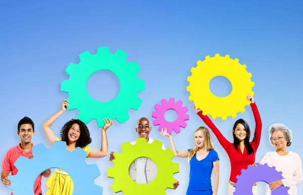 Diversity People holding Gears — Stock Photo, Image