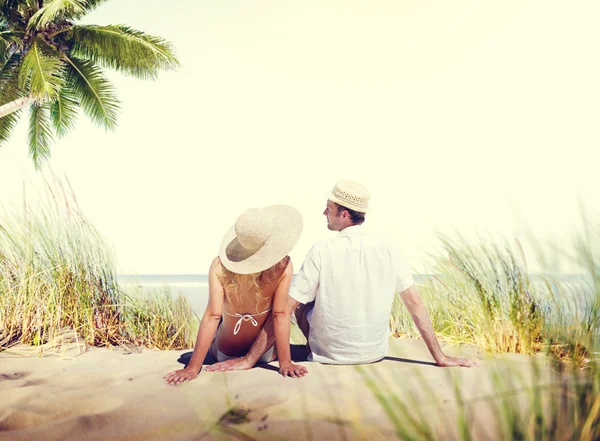 Coppia seduta sulla spiaggia — Foto Stock