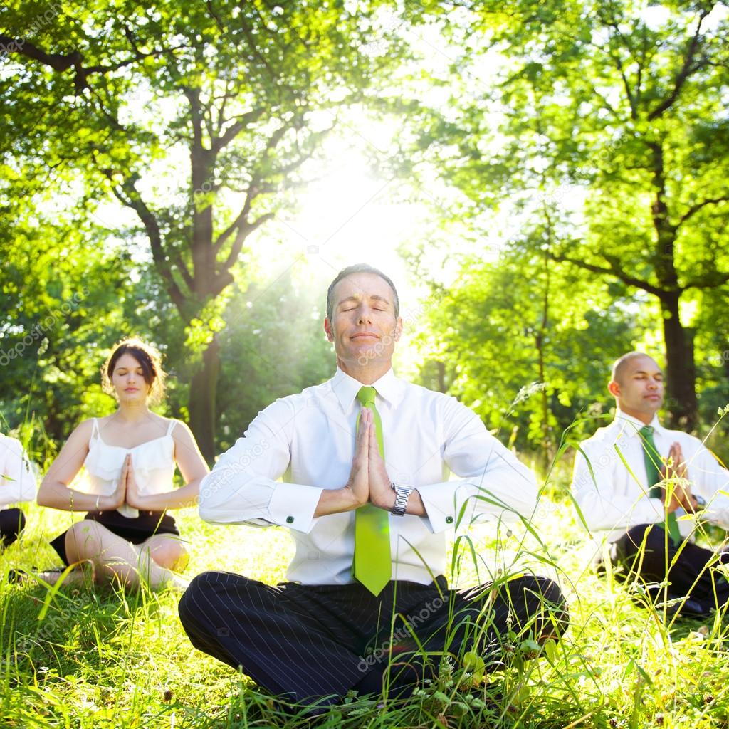 Business People Meditating in forest