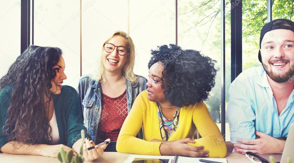 Diverse college students brainstorming in classroom