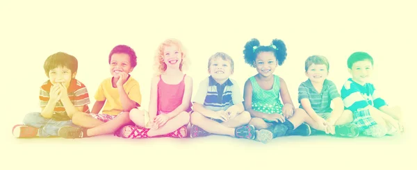 Різноманітність дітей, що сидять разом — стокове фото
