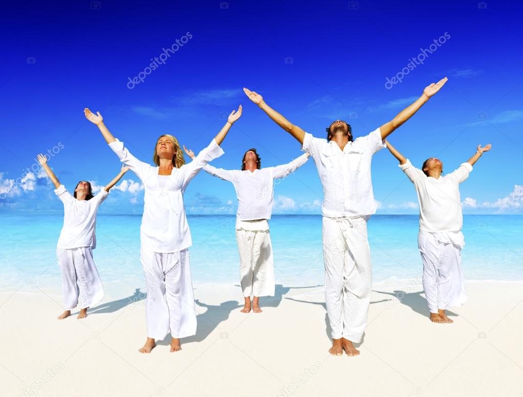 People performing yoga on the beach Concept