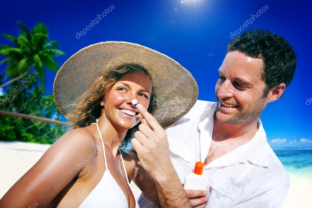 Couple applying Sun Protection Concept